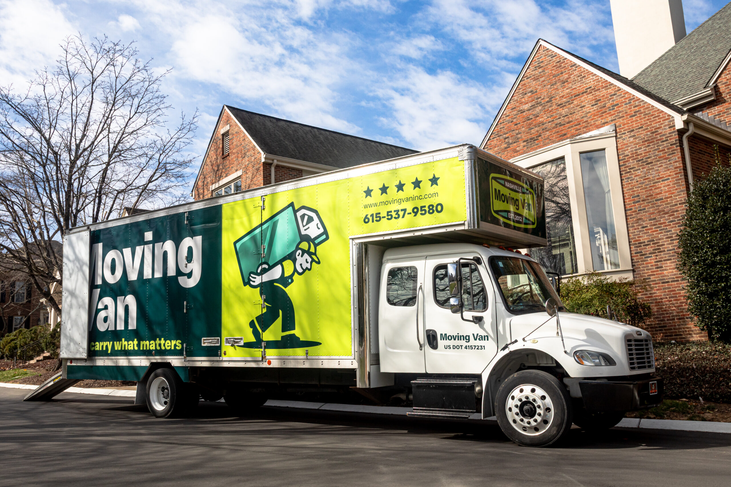 residential-moving A large white moving van with green and yellow branding is parked on a suburban street. The van features bold text and a cartoon figure, giving a professional and approachable impression.